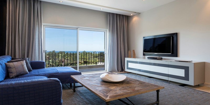 Living Room With Patio Doors Opening To Terrace And Stunning Ocean Views