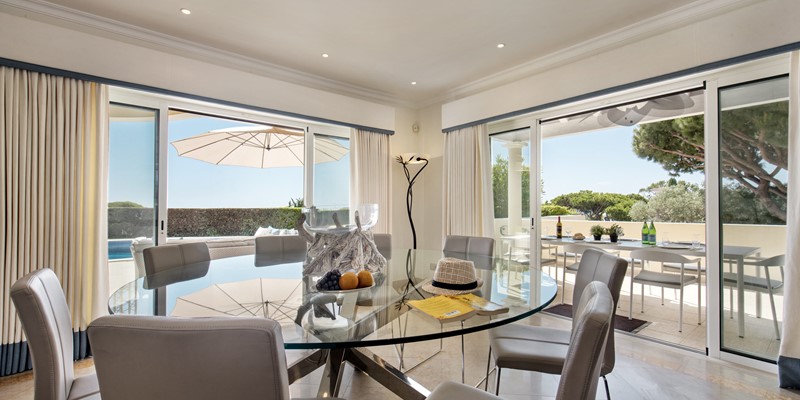 Dining Area In Open Plan Living Room With Pool Views