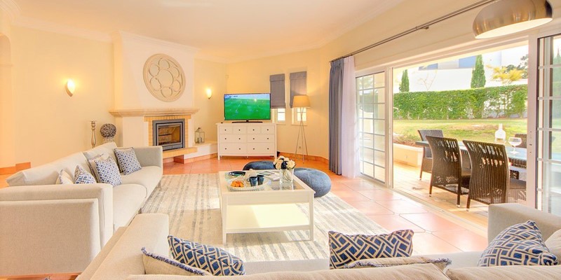 Bright Living Room With Patio Doors Out To Garden And Pool